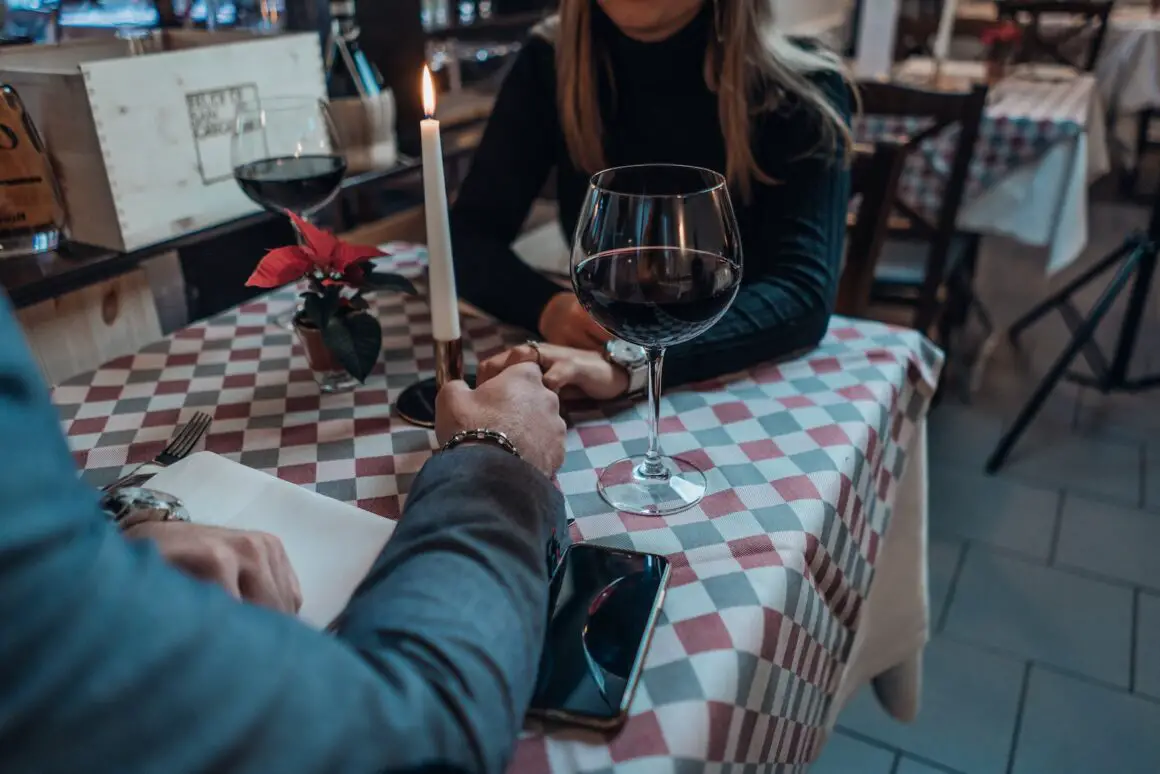 woman wearing black sweater holding hand with man wearing gray suit jacket - date ideen mylocalwedding