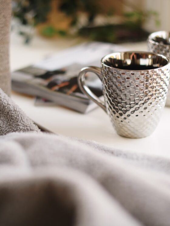 two silver mugs on white side table - Geschenke zur Silberhochzeit