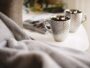 two silver mugs on white side table - Geschenke zur Silberhochzeit